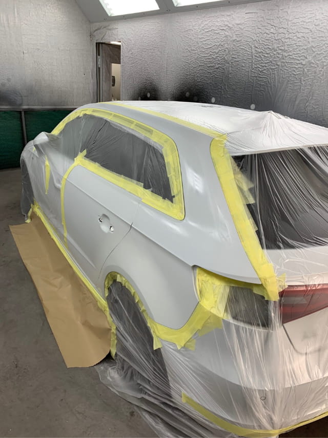 The Audi prepared for paint in the spray booth