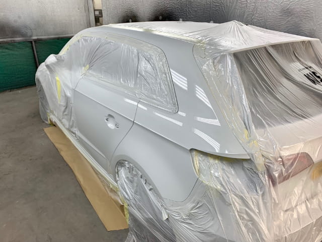 The Audi prepared for paint in the spray booth