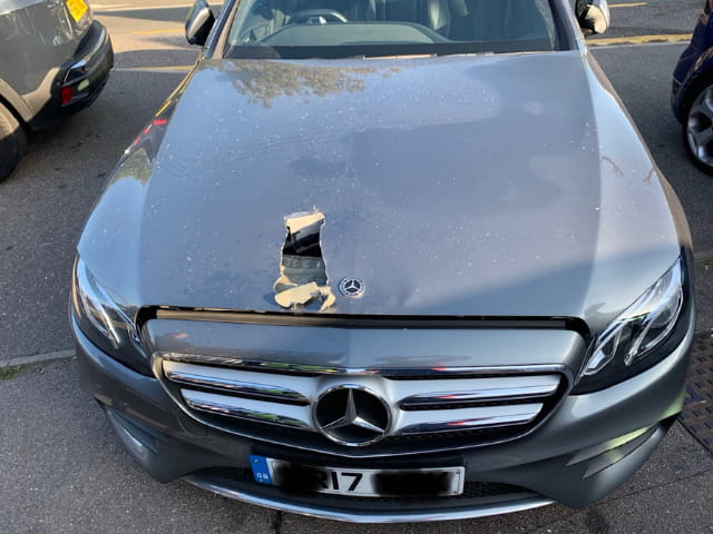 Close up of the Mercedes with the bonnet damage