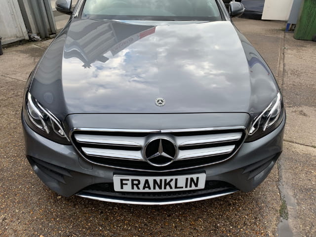 A close up of the Mercedes and the repaired bonnet